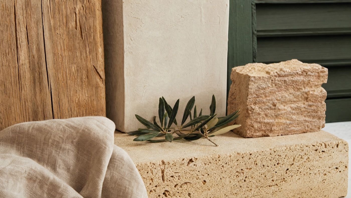 Natural materials: aged timber, lime, marès stone and an olive branch
